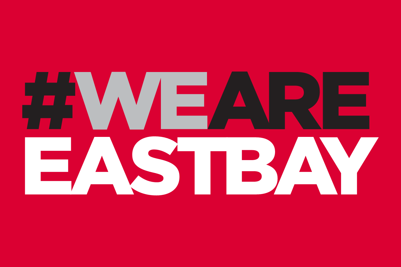 #WEARE EASTBAY wordmark, stacked 2 lines, white on red variant, cell 75