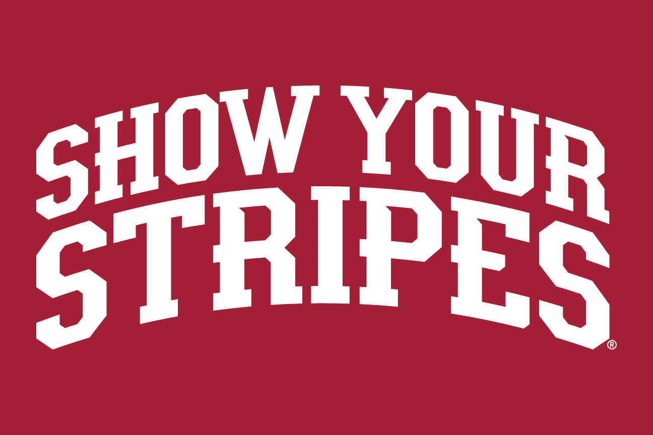 SHOW YOUR STRIPES wordmark, arched white on crimson variant, cell 48